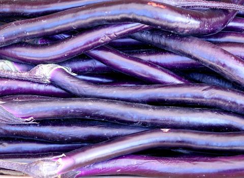 Deep purple eggplants for sale at the market