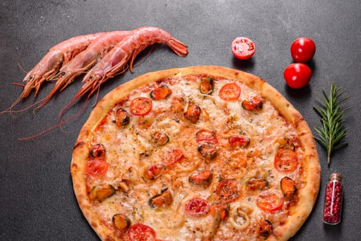 Seafood Italian pizza with shrimp, squid, mussels, fresh herbs and mozzarella on a
dark background. Tasty sliced pizza with seafood and tomato on a concrete background