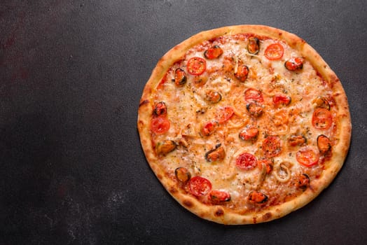 Seafood Italian pizza with shrimp, squid, mussels, fresh herbs and mozzarella on a
dark background. Tasty sliced pizza with seafood and tomato on a concrete background