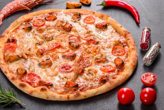 Seafood Italian pizza with shrimp, squid, mussels, fresh herbs and mozzarella on a
dark background. Tasty sliced pizza with seafood and tomato on a concrete background