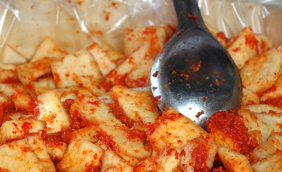 An outdoor vendor sells Kimchi, that is fermented spicy cabbage
