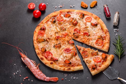Seafood Italian pizza with shrimp, squid, mussels, fresh herbs and mozzarella on a
dark background. Tasty sliced pizza with seafood and tomato on a concrete background
