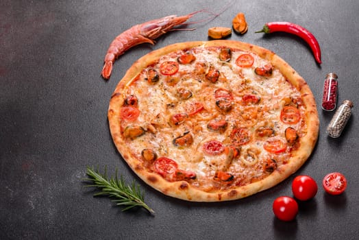 Seafood Italian pizza with shrimp, squid, mussels, fresh herbs and mozzarella on a
dark background. Tasty sliced pizza with seafood and tomato on a concrete background