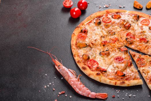Seafood Italian pizza with shrimp, squid, mussels, fresh herbs and mozzarella on a
dark background. Tasty sliced pizza with seafood and tomato on a concrete background