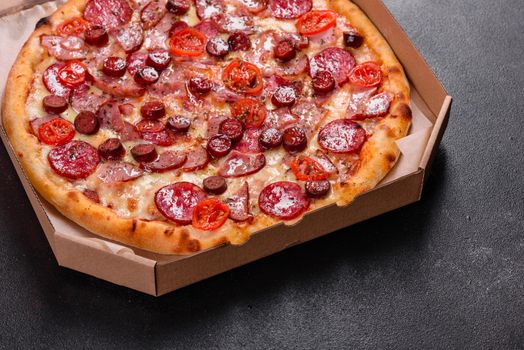 Pepperoni Pizza with Mozzarella cheese, salami, ham. Italian pizza on a dark background