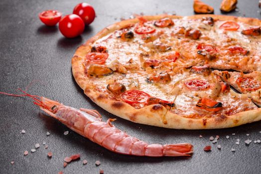 Seafood Italian pizza with shrimp, squid, mussels, fresh herbs and mozzarella on a
dark background. Tasty sliced pizza with seafood and tomato on a concrete background