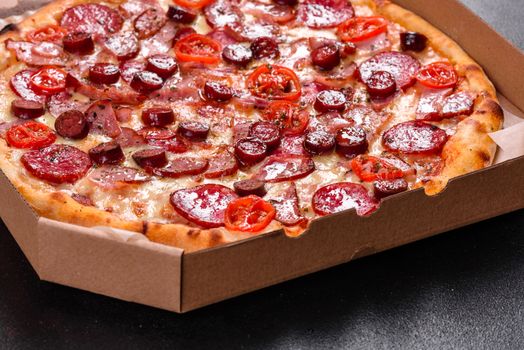 Pepperoni Pizza with Mozzarella cheese, salami, ham. Italian pizza on a dark background
