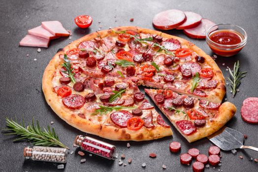 Pepperoni Pizza with Mozzarella cheese, salami, ham. Italian pizza on a dark background