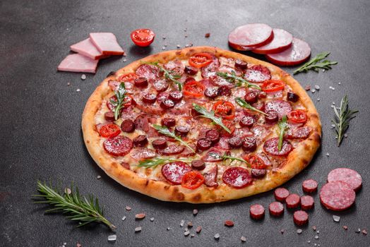 Pepperoni Pizza with Mozzarella cheese, salami, ham. Italian pizza on a dark background