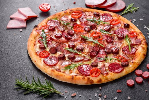 Pepperoni Pizza with Mozzarella cheese, salami, ham. Italian pizza on a dark background