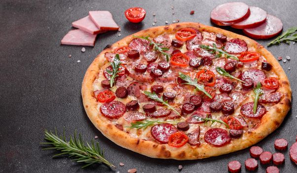 Pepperoni Pizza with Mozzarella cheese, salami, ham. Italian pizza on a dark background