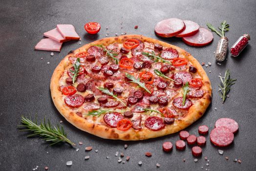 Pepperoni Pizza with Mozzarella cheese, salami, ham. Italian pizza on a dark background