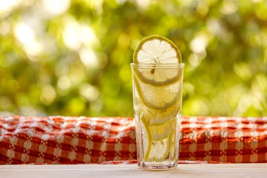 Citrus lemonade in garden setting, summer drink.