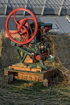 An antique steam operated machine for producing straw mats. Over 100 years old.