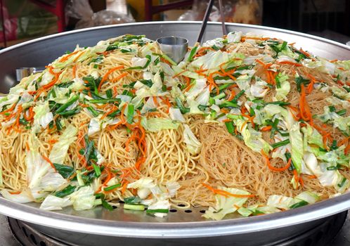 Chinese fried noodles with cabbage, chives and carrots
