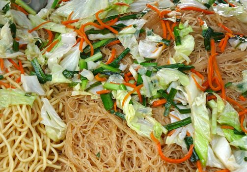 Chinese fried noodles with cabbage, chives and carrots