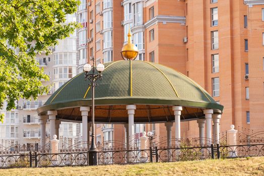 Gazebo in the Naltalka park of Kiev, Ukraine, near the high buildings of the Obolon district
