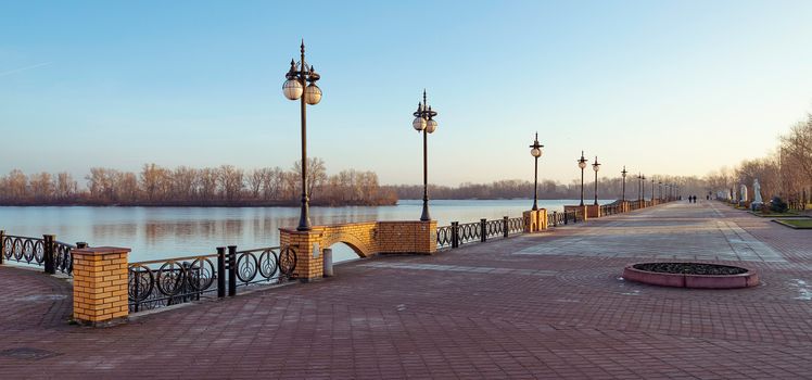 Walkway along the Dnieper River in the Obolon district of Kiev, Ukraine. Soft sun during a cold winter morning.