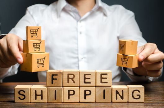 A man holds boxes over the inscription free shipping. Promotions preferential terms for large customers and product groups. Transportation of goods and services, distribution and delivery of orders.