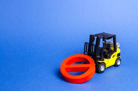 A yellow forklift truck cannot lift a red NO symbol. The concept of prohibition, sanctions and restrictions. Overcoming, bypassing difficulties. solving complex engineering and technical problems