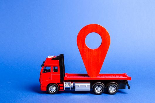 Red truck carries a red pointer location. Services transportation of goods and products, logistics and infrastructure. Transportation company Warehousing and supply. Location and control of carriers.