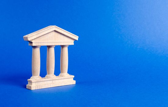 Building figurine with pillars in antique style. Concept of city administration, bank, university, court or library. Architectural monument in the old part of the city. Banking, education, government.