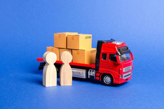 A red truck loaded with boxes near a customer buyer and seller. Business and commerce. Negotiations on supply of goods. Services transportation of goods and products, logistics Transportation company.