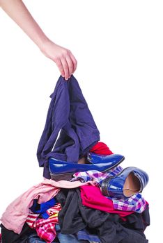 Hand put one item to pile of old used clothes isolated on white background