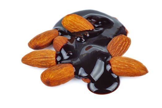 Homemade liquid dark chocolate and almonds isolated on white background