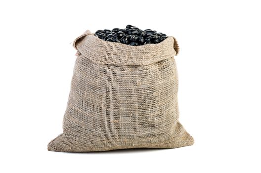 Jute sack with black legume beans isolated on white background
