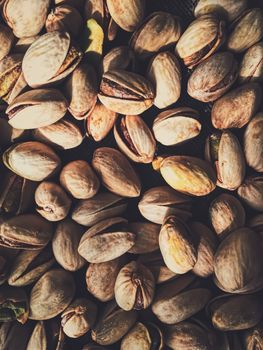 Pistachio nuts on rustic linen background, food and nutrition