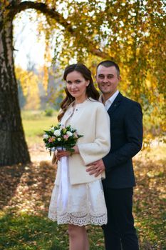 Couple in love close-up portrait. Young male and woman just married. Concept of happy family. Modern family outdoor. Adorable family demonstrate love and care. Autumn vacation.