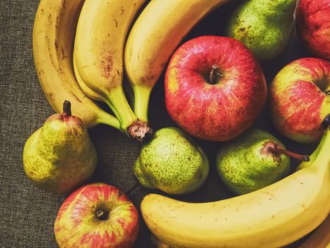 Organic apples, pears and bananas on rustic linen background, fruits farming and agriculture