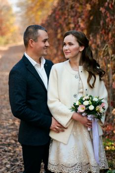 Couple in love close-up portrait. Young male and woman just married. Concept of happy family. Modern family outdoor. Adorable family demonstrate love and care. Autumn vacation.