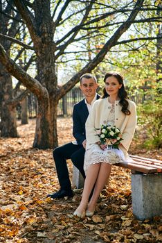 Couple in love close-up portrait. Young male and woman just married. Concept of happy family. Modern family outdoor. Adorable family demonstrate love and care. Autumn vacation.