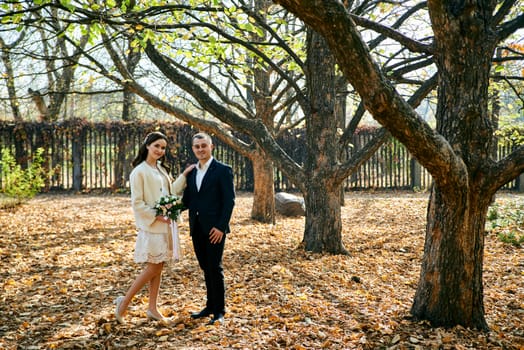 Couple in love close-up portrait. Young male and woman just married. Concept of happy family. Modern family outdoor. Adorable family demonstrate love and care. Autumn vacation.