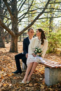 Couple in love close-up portrait. Young male and woman just married. Concept of happy family. Modern family outdoor. Adorable family demonstrate love and care. Autumn vacation.