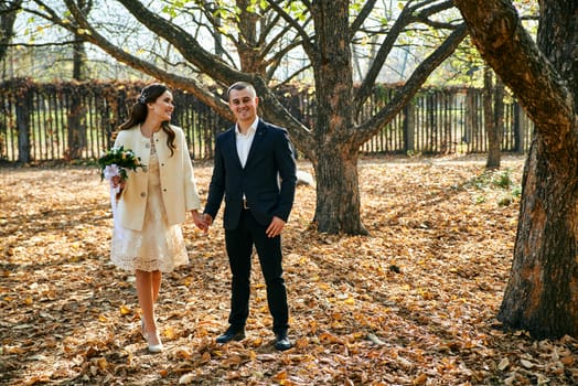 Couple in love close-up portrait. Young male and woman just married. Concept of happy family. Modern family outdoor. Adorable family demonstrate love and care. Autumn vacation.