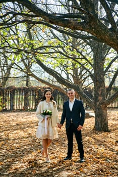 Couple in love close-up portrait. Young male and woman just married. Concept of happy family. Modern family outdoor. Adorable family demonstrate love and care. Autumn vacation.