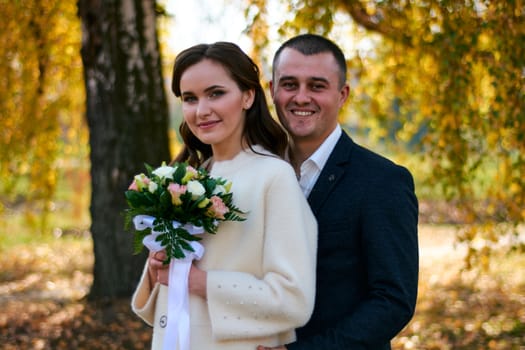 Couple in love close-up portrait. Young male and woman just married. Concept of happy family. Modern family outdoor. Adorable family demonstrate love and care. Autumn vacation.