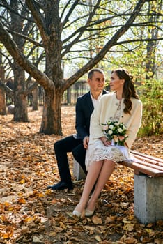 Couple in love close-up portrait. Young male and woman just married. Concept of happy family. Modern family outdoor. Adorable family demonstrate love and care. Autumn vacation.