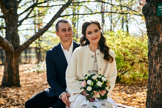 Couple in love close-up portrait. Young male and woman just married. Concept of happy family. Modern family outdoor. Adorable family demonstrate love and care. Autumn vacation.