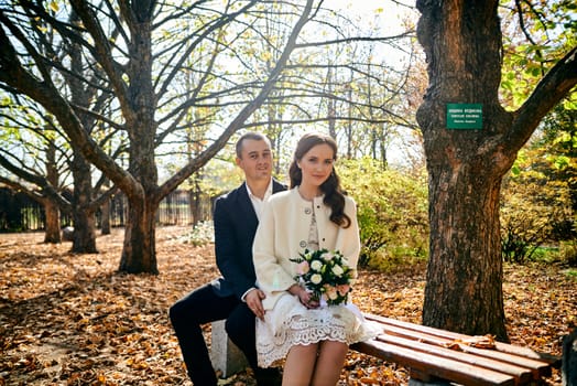 Couple in love close-up portrait. Young male and woman just married. Concept of happy family. Modern family outdoor. Adorable family demonstrate love and care. Autumn vacation.