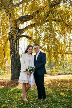 Couple in love close-up portrait. Young male and woman just married. Concept of happy family. Modern family outdoor. Adorable family demonstrate love and care. Autumn vacation.