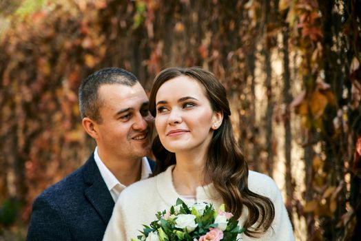 Couple in love close-up portrait. Young male and woman just married. Concept of happy family. Modern family outdoor. Adorable family demonstrate love and care. Autumn vacation.