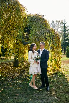 Couple in love close-up portrait. Young male and woman just married. Concept of happy family. Modern family outdoor. Adorable family demonstrate love and care. Autumn vacation.