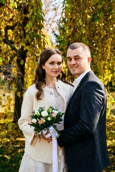 Couple in love close-up portrait. Young male and woman just married. Concept of happy family. Modern family outdoor. Adorable family demonstrate love and care. Autumn vacation.