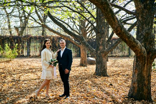 Couple in love close-up portrait. Young male and woman just married. Concept of happy family. Modern family outdoor. Adorable family demonstrate love and care. Autumn vacation.