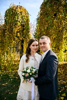 Couple in love close-up portrait. Young male and woman just married. Concept of happy family. Modern family outdoor. Adorable family demonstrate love and care. Autumn vacation.