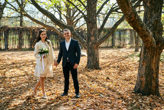 Couple in love close-up portrait. Young male and woman just married. Concept of happy family. Modern family outdoor. Adorable family demonstrate love and care. Autumn vacation.